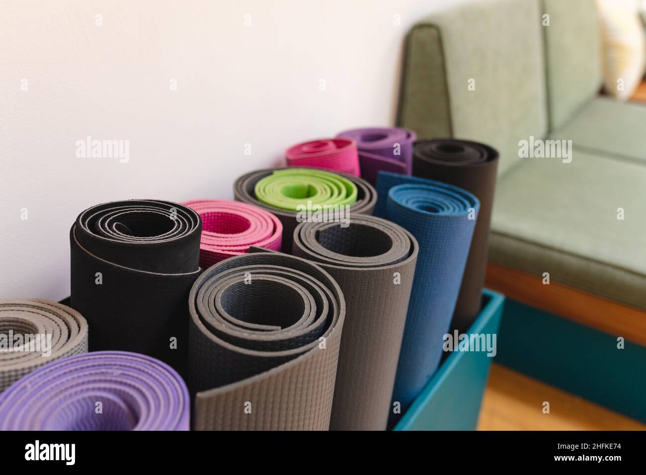 Closeup of rolled up colorful exercise mats in yoga studio Stock Photo -  Alamy
