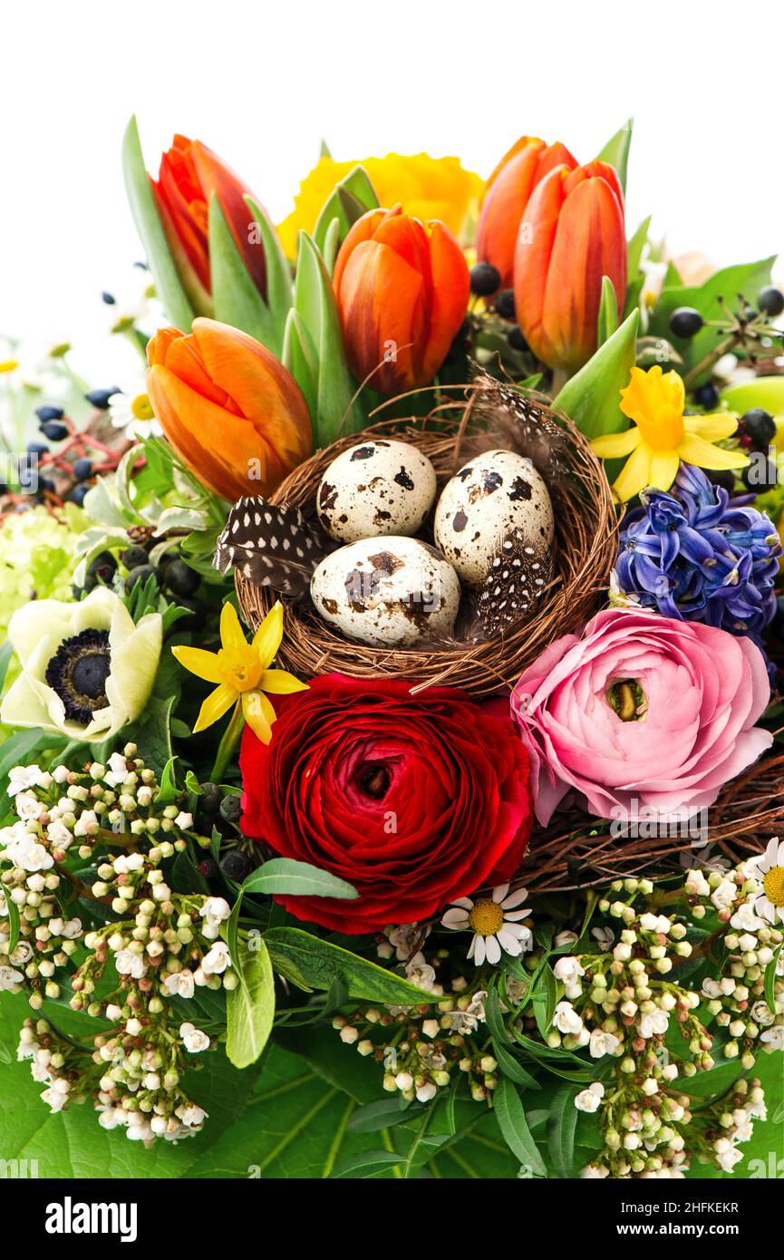 Easter flowers bouquet with eggs decoration. Spring blooms tulip, ranunculus, hyacinth, daisy, anemone Stock Photo