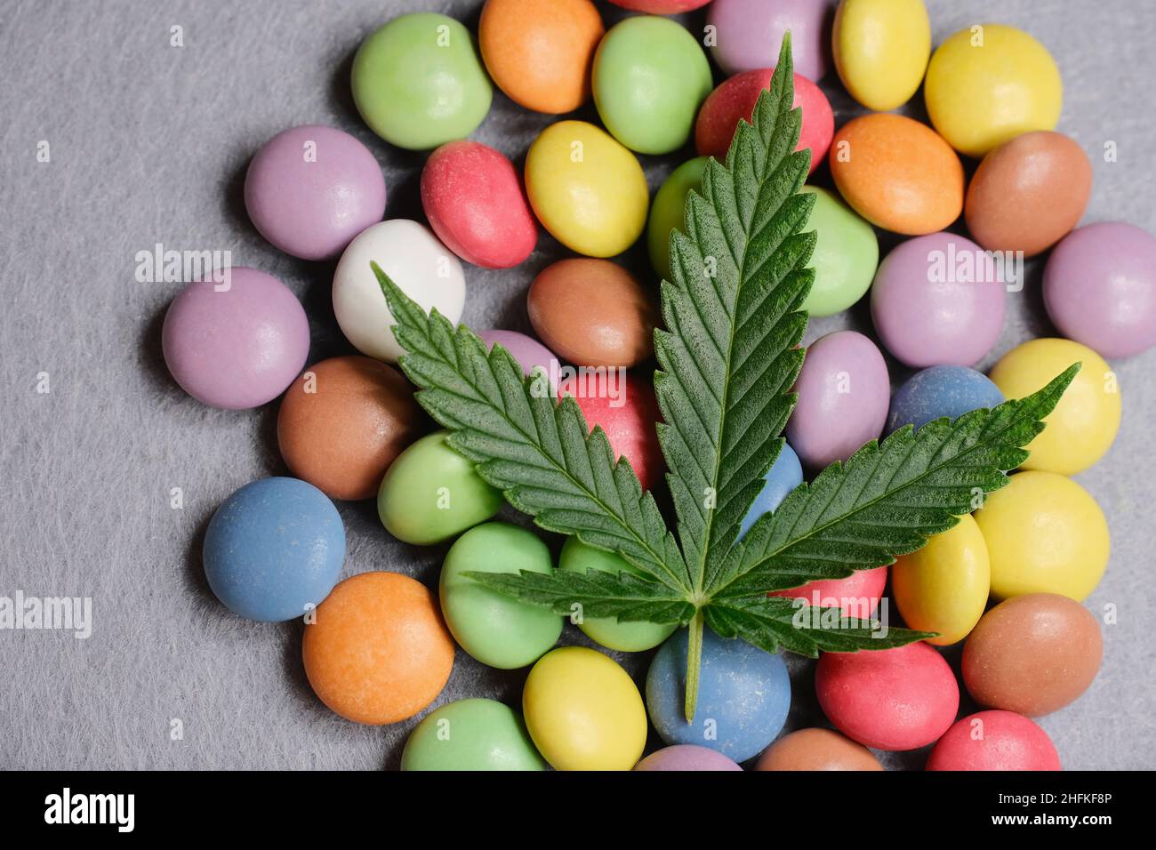 Marijuana Sweets Cannabis leaf with colorful candy confetti close up. Marijuana sweets ...