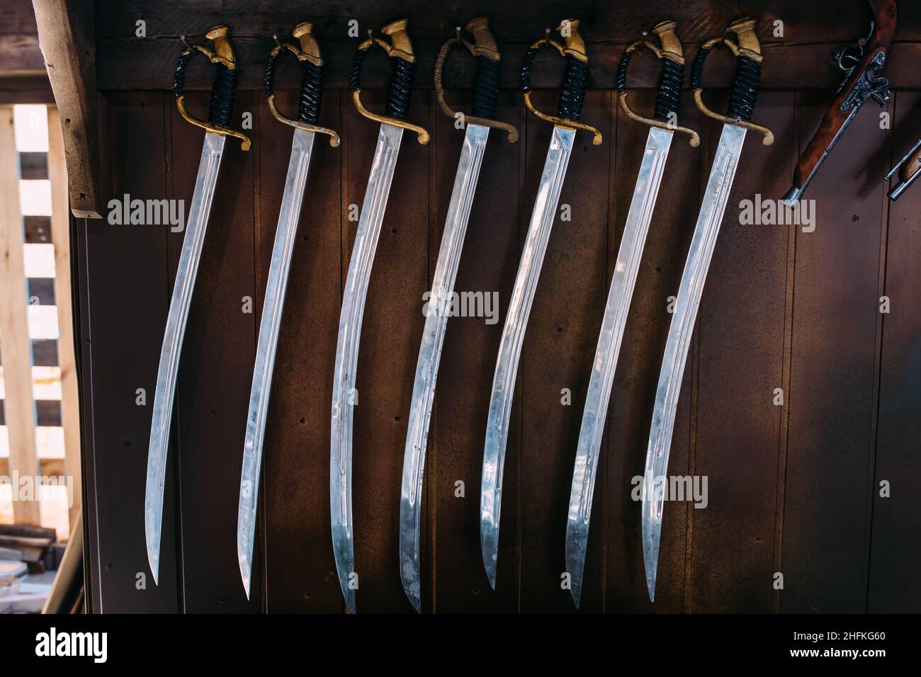A set of old swords on the shelves of souvenir shops. Medieval saber