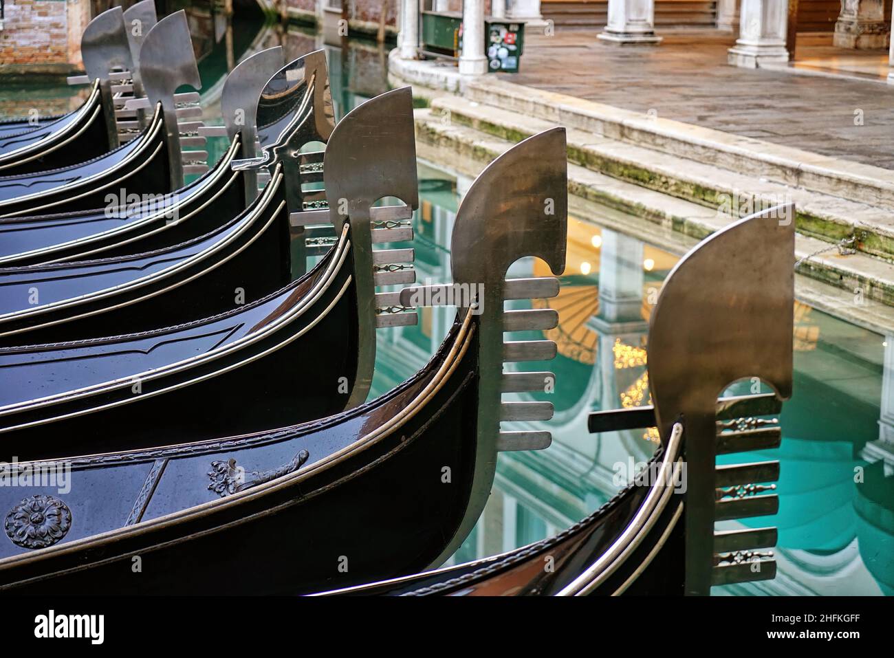 Detail on the steel bow of Venetian gondolas moored in Venice, Italy. Stock Photo