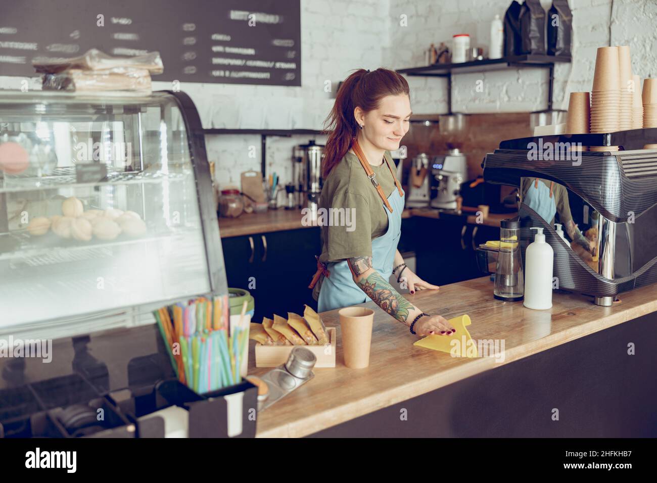 Female barista cleaning counter in cafe or coffee shop Stock Photo Alamy