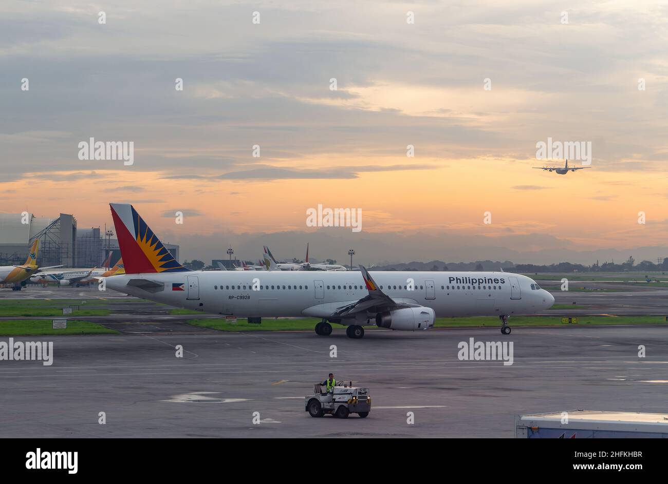 Philippine Airlines Airbus A321 ready for departure early in the morning, before sunrise, at Terminal 2 of Ninoy Aquino International Airport in Manil Stock Photo