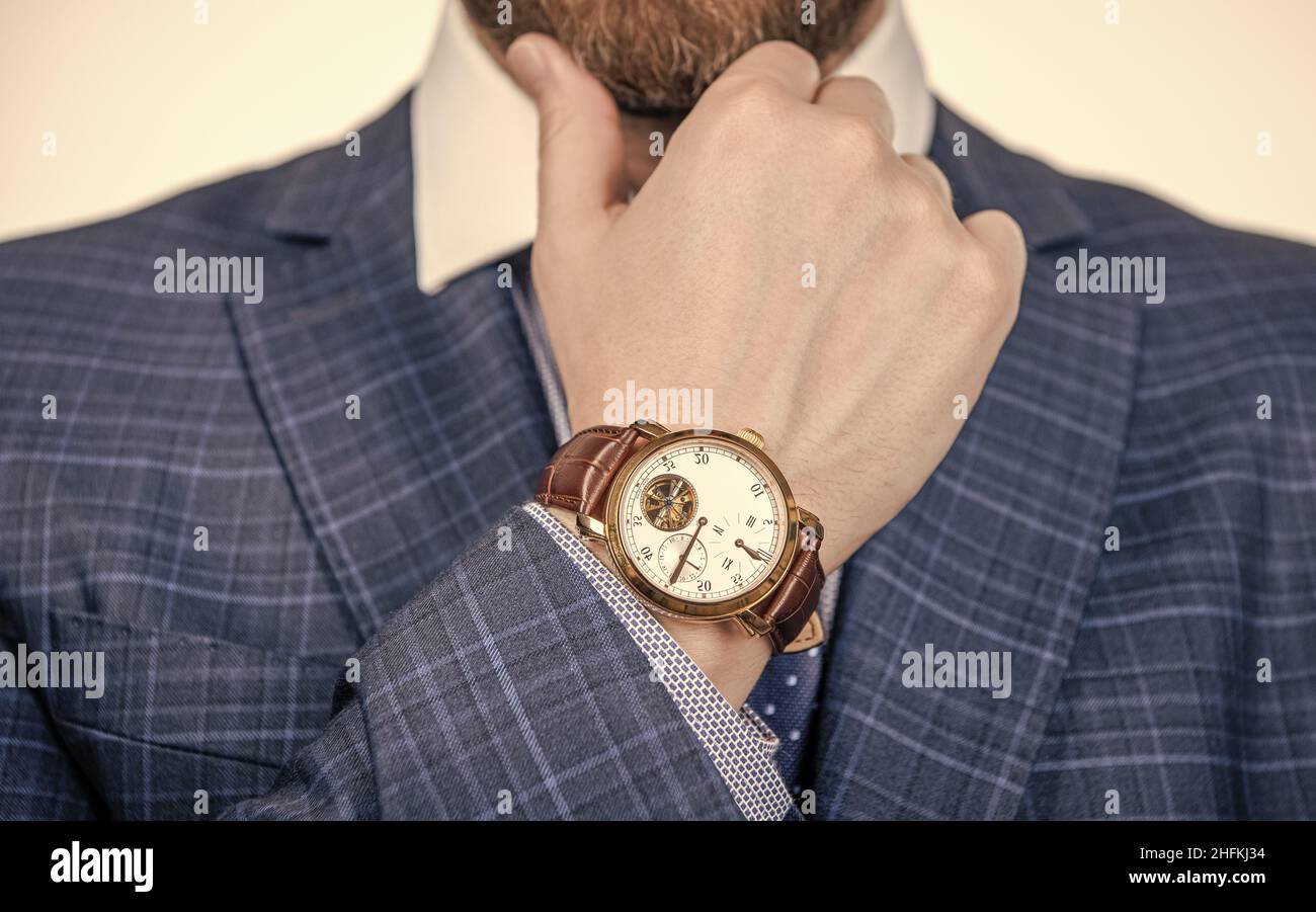 Class is timeless. Wristwatch worn on male arm wrist. Business wristwatch collection. Time management Stock Photo