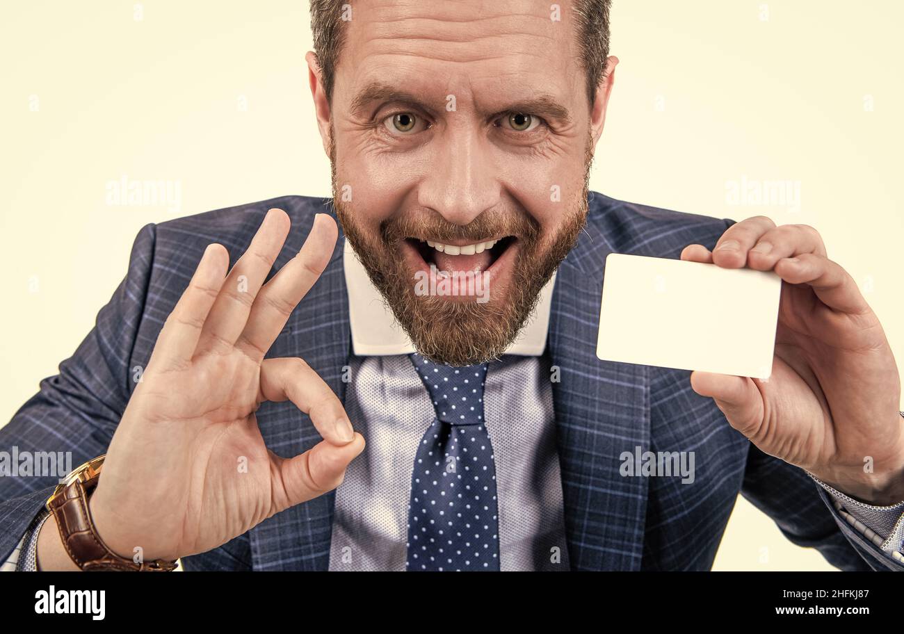 happy businessman man in businesslike suit showing empty debit or business card for copy space Stock Photo