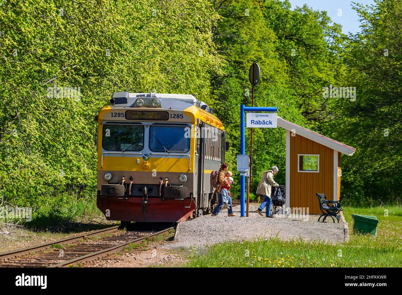Train stop in the countryside with disembarking passengers Stock Photo
