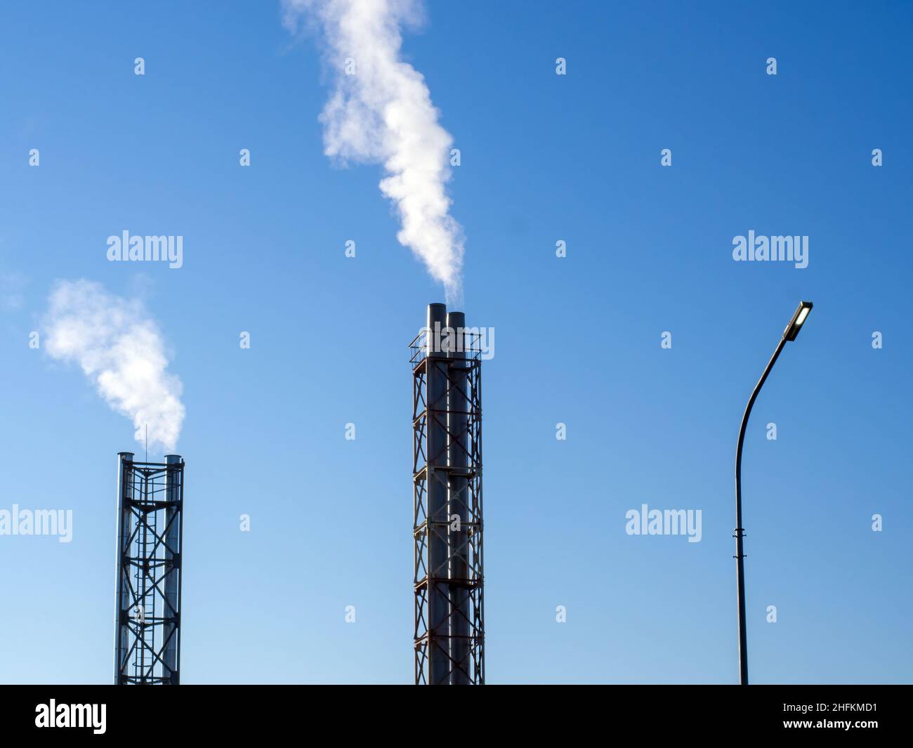 white smoke from the chimney of the chock, against the blue sky Stock ...