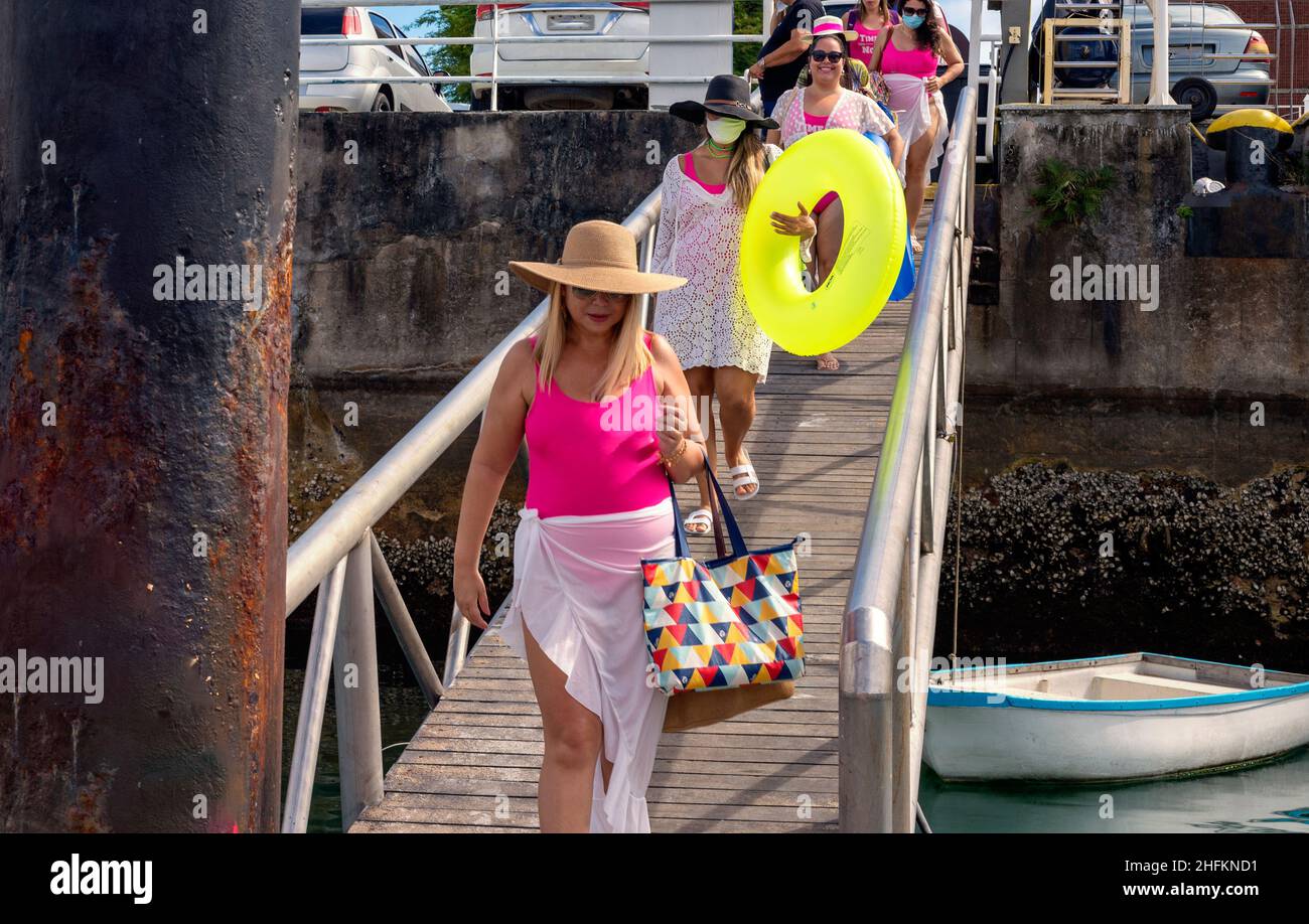 Women in bikinis walking down a walkway to the pier. Salvador, Bahia, Brazil. Stock Photo