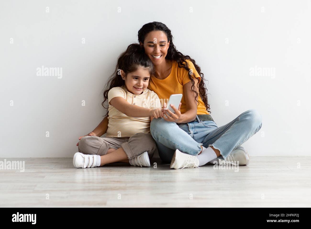 Kids And Technologies. Little Girl Using Smartphone With Mom At Home ...