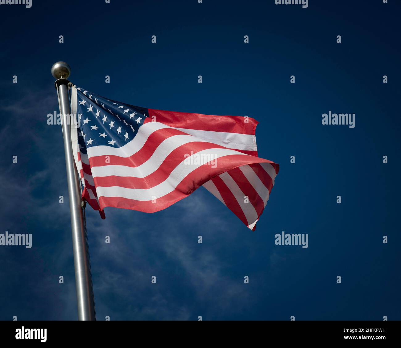 Flag of the United States of America against a blue sky Stock Photo - Alamy