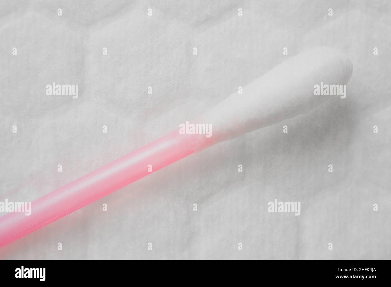 Cotton swab on white microfiber background. Contamination control and