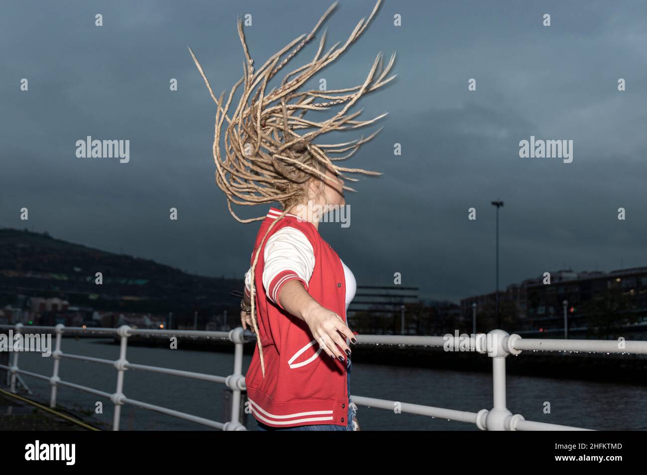 blonde woman with dreadlocks wagging her hair Stock Photo