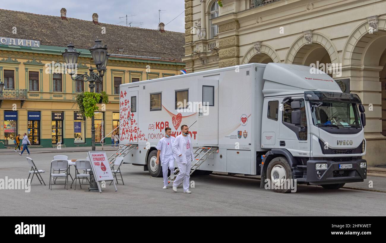 Novi Sad, Serbia - September 21, 2021: Two Nurses in Front of Bloodmobile Truck Mobile Blood Donation Center at City Square. Stock Photo