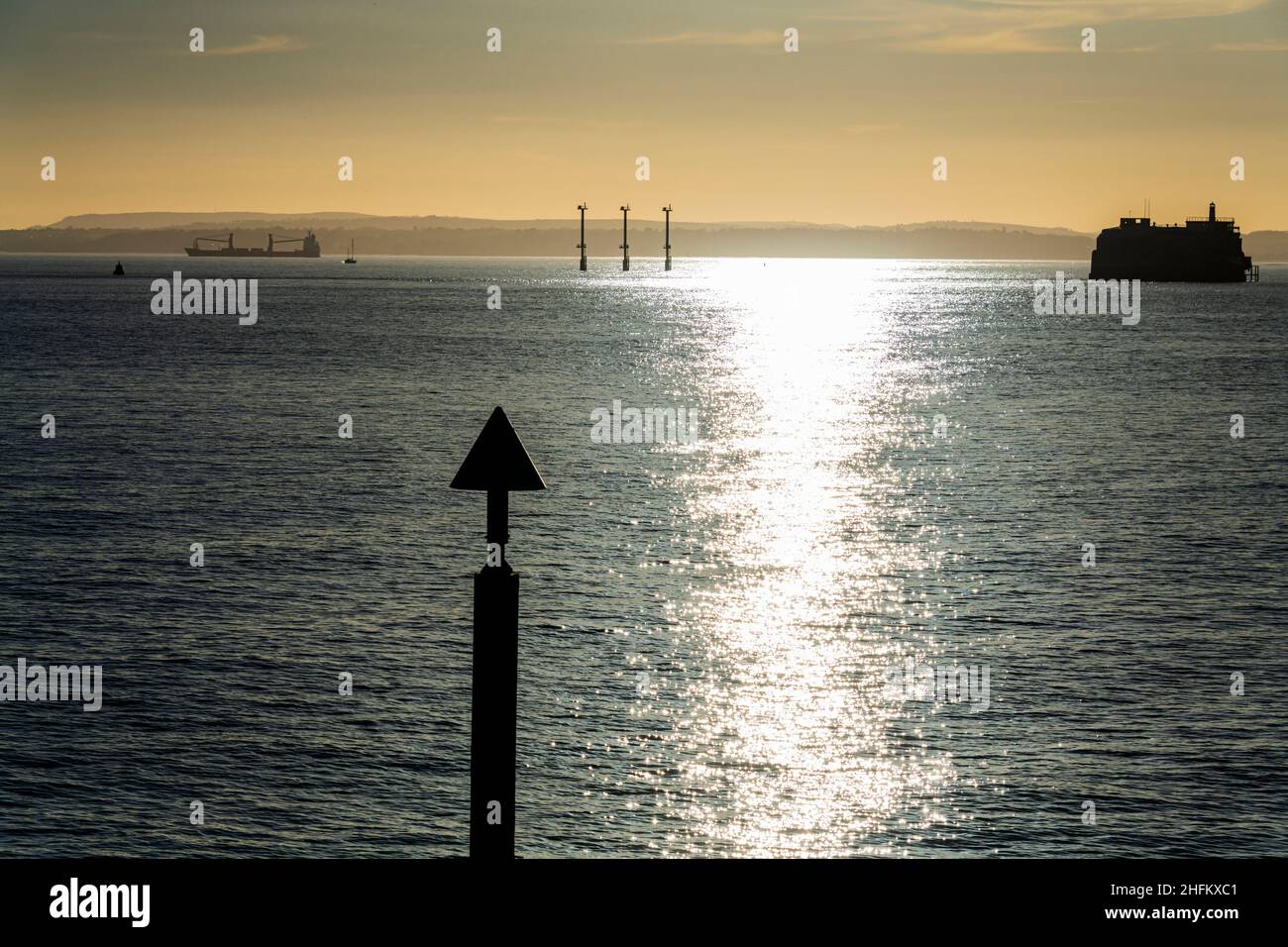 A Tanker passes along the Solent and Horse Sand Fort at sunset off ...