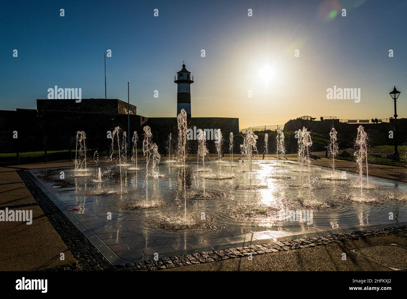 The fountains outside Southsea Castle, silhouetted against the setting sun. Stock Photo