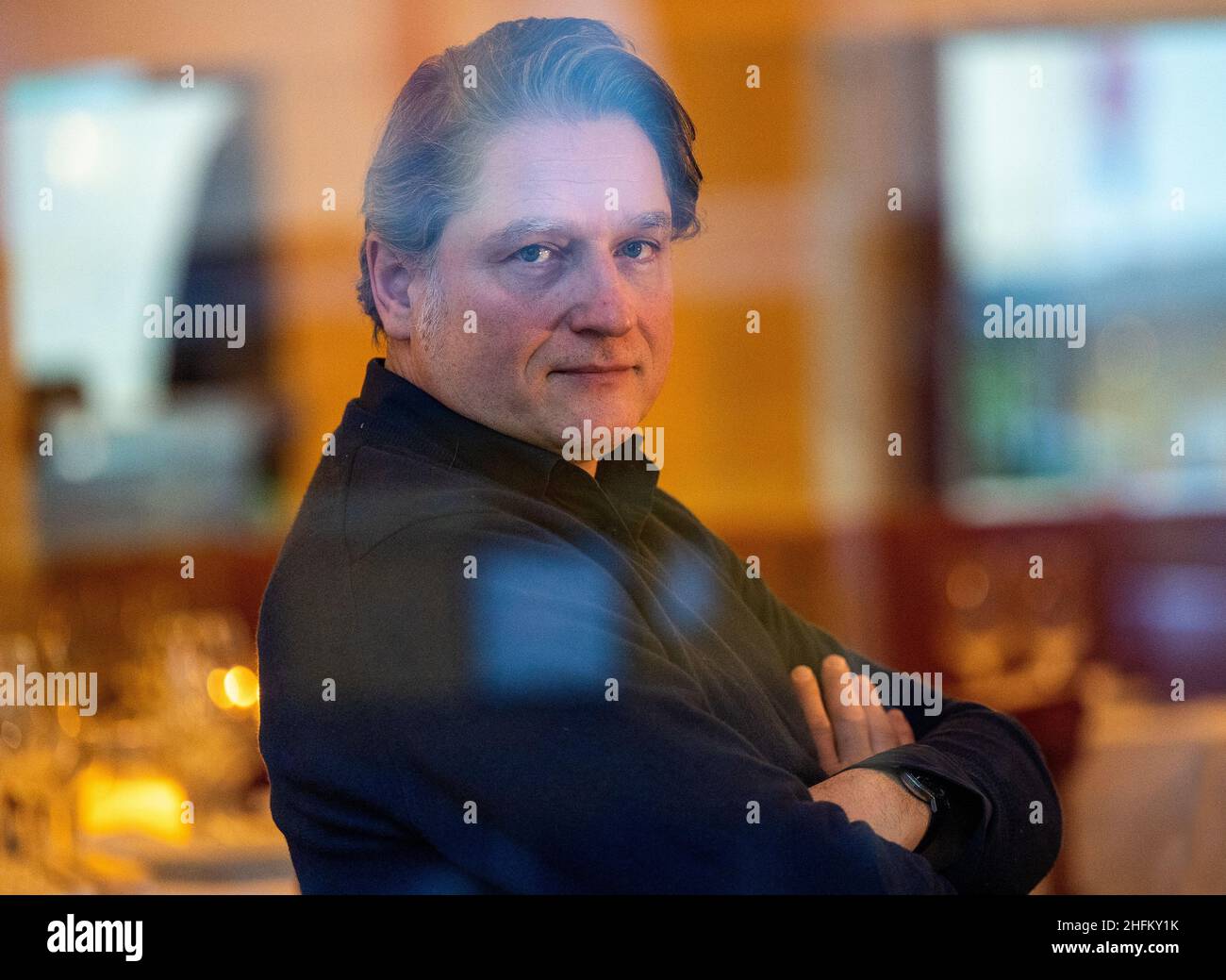 Berlin, Germany. 14th Jan, 2022. Jakob Augstein, publisher, journalist and author, sits in a Berlin restaurant. Augstein's first novel 'Strömung' will be published by Aufbau Verlag on January 17, 2022. Credit: Monika Skolimowska/dpa-Zentralbild/dpa/Alamy Live News Stock Photo