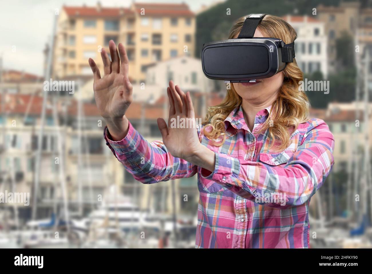 Girl wearing VR glasses on city buildings background Stock Photo - Alamy