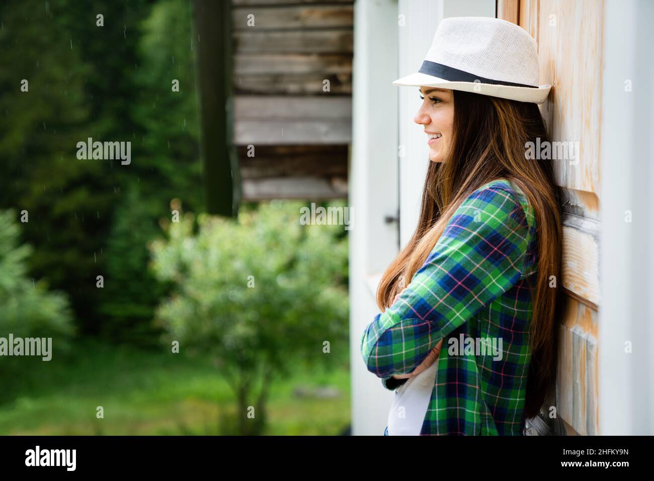 Beautiful young brunette woman with long hair and hat in park Stock ...