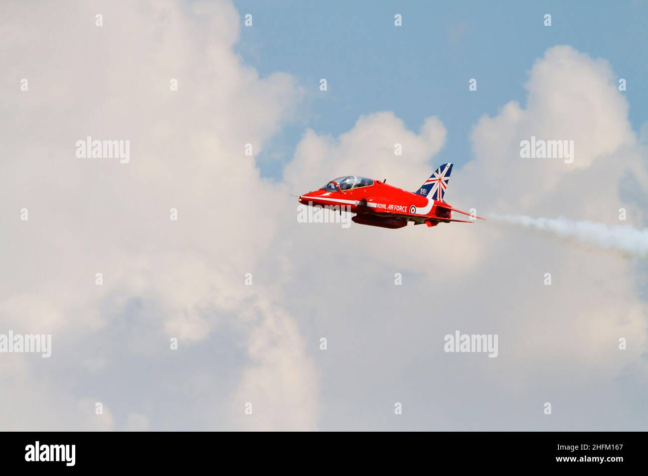 Single synchro pair BAE Hawk T1a aircraft of the Royal Air Force aerobatic display team, The Red Arrows, with the 50th Anniversity tail markings. . RA Stock Photo