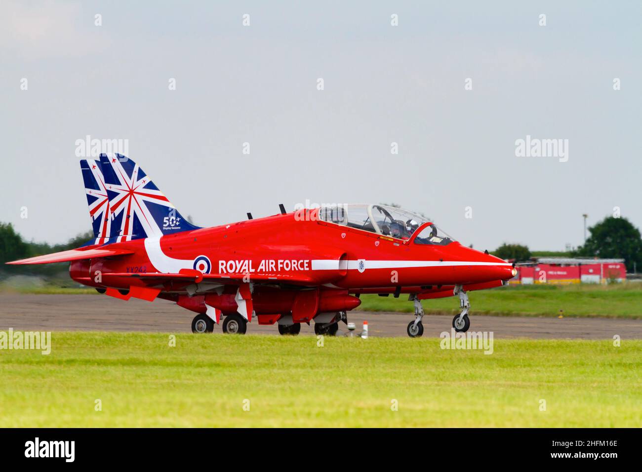 Two BAE Hawk T1a aircraft of the Royal Air Force aerobatic display team, The Red Arrows, with the 50th Anniversity tail markings. Accelerating to take Stock Photo