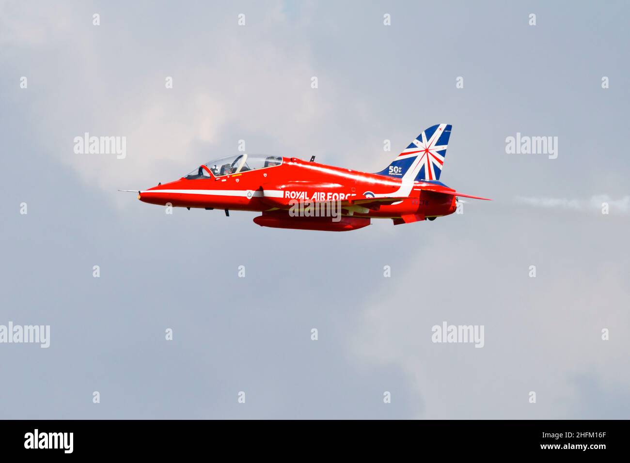 Single synchro pair BAE Hawk T1a aircraft of the Royal Air Force aerobatic display team, The Red Arrows, with the 50th Anniversity tail markings. . RA Stock Photo
