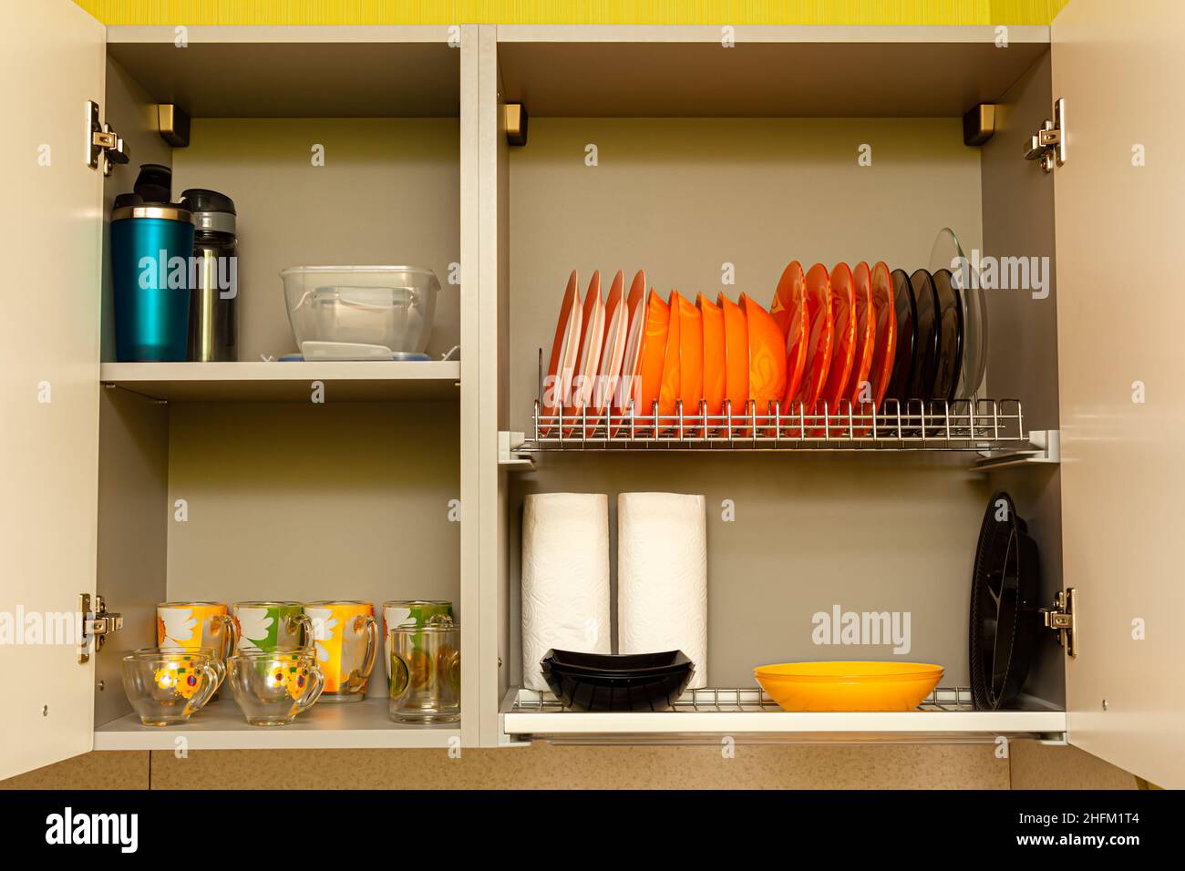 kitchen utensils and utensils are on the shelf of the kitchen