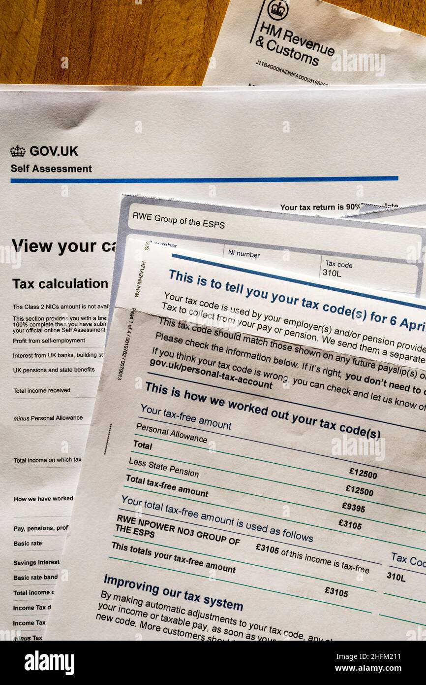 Documents ready for completing a UK self-assessment tax form.  NB: Data anonymised. Stock Photo