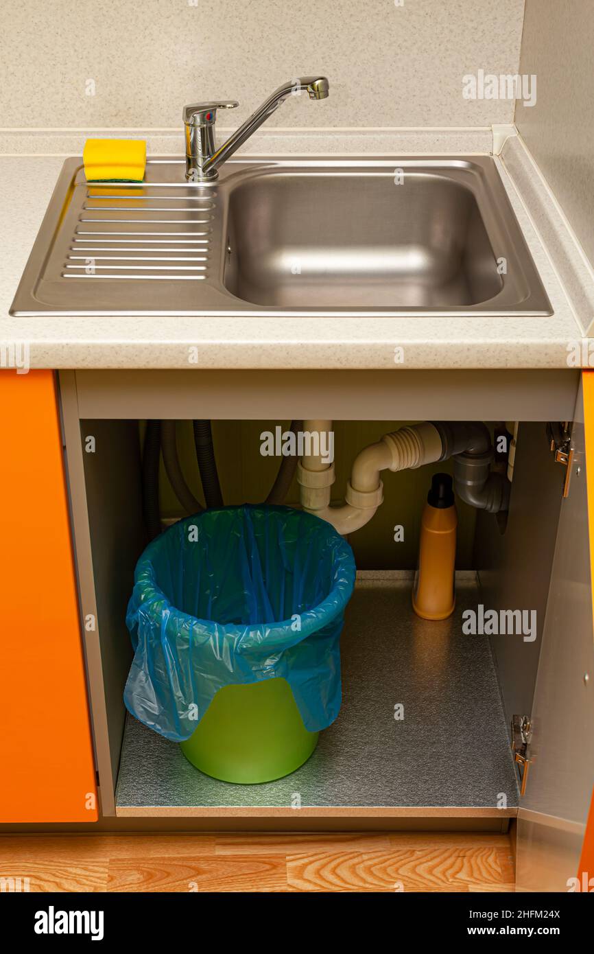 trash can with package under the kitchen sink. High quality photo Stock
