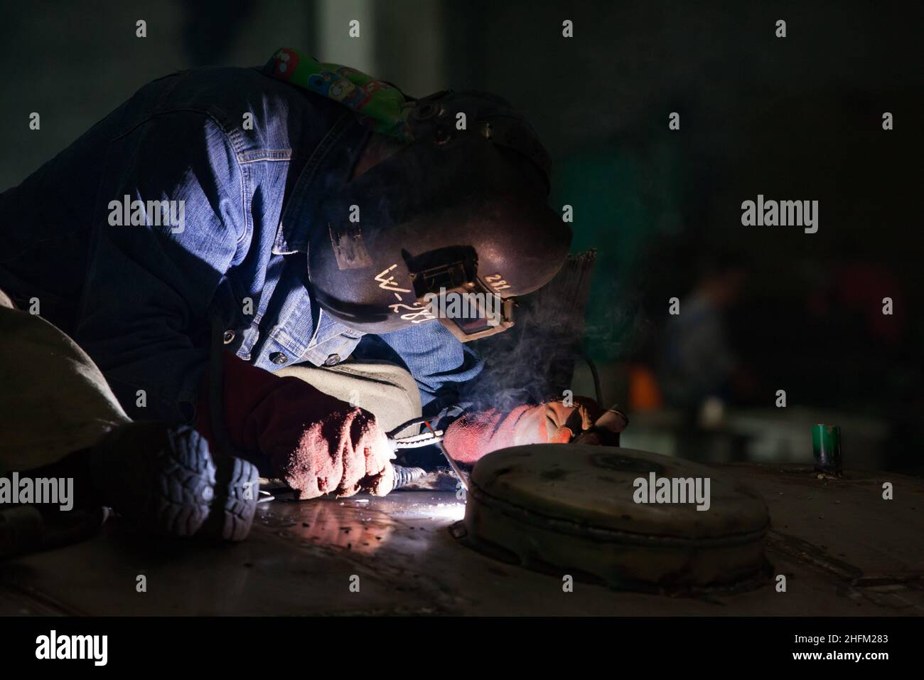 Welder in work. Dark background. Close-up. Uralsk city, Kazakhstan. Stock Photo