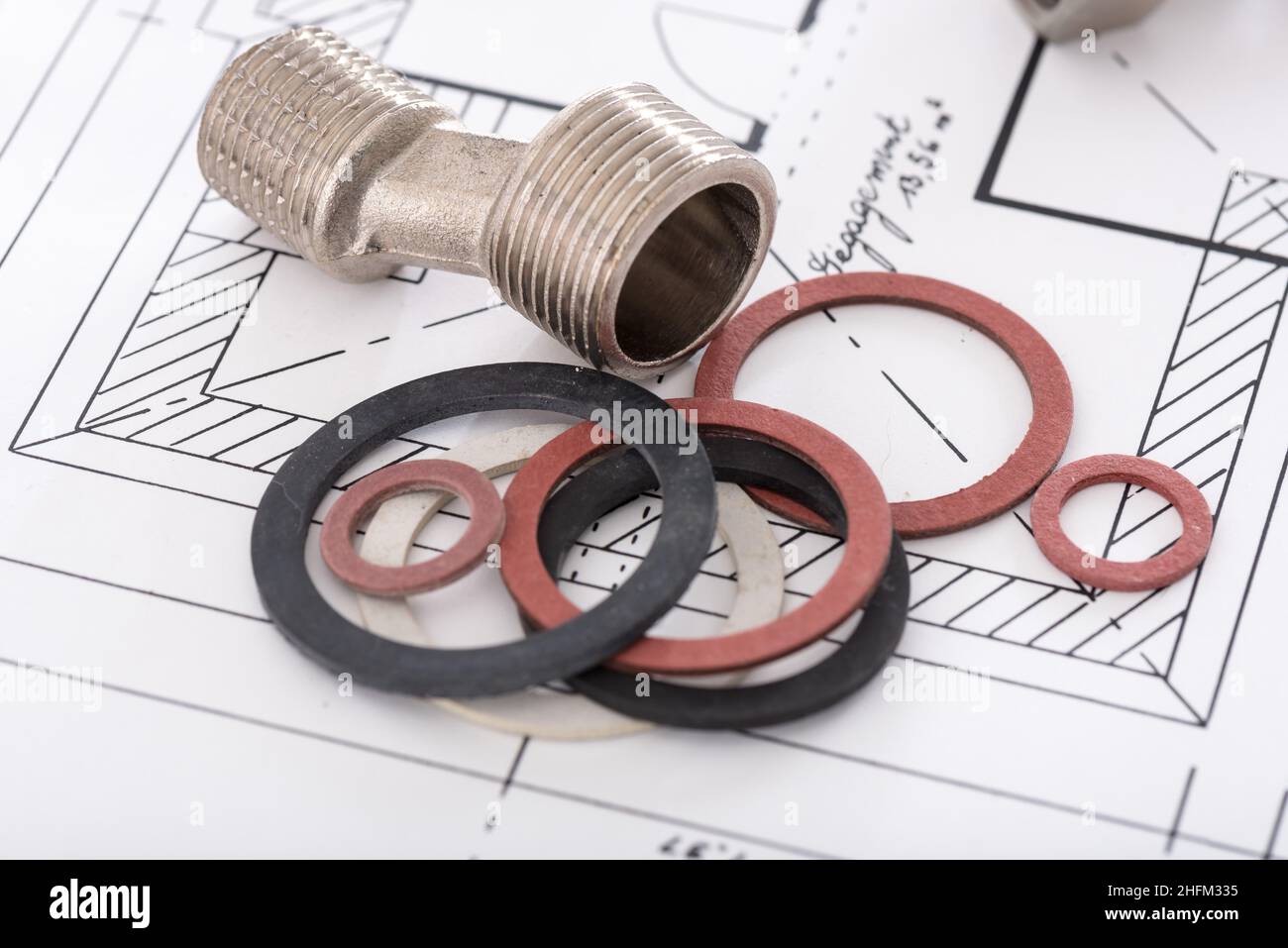 Plumbing fittings and gaskets on a plan Stock Photo Alamy