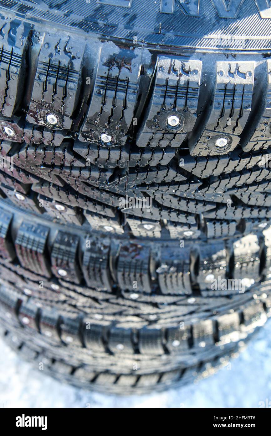 The detail of the new winter tyres with studs for precise driving control on ice and snow in slippery conditions. Stock Photo