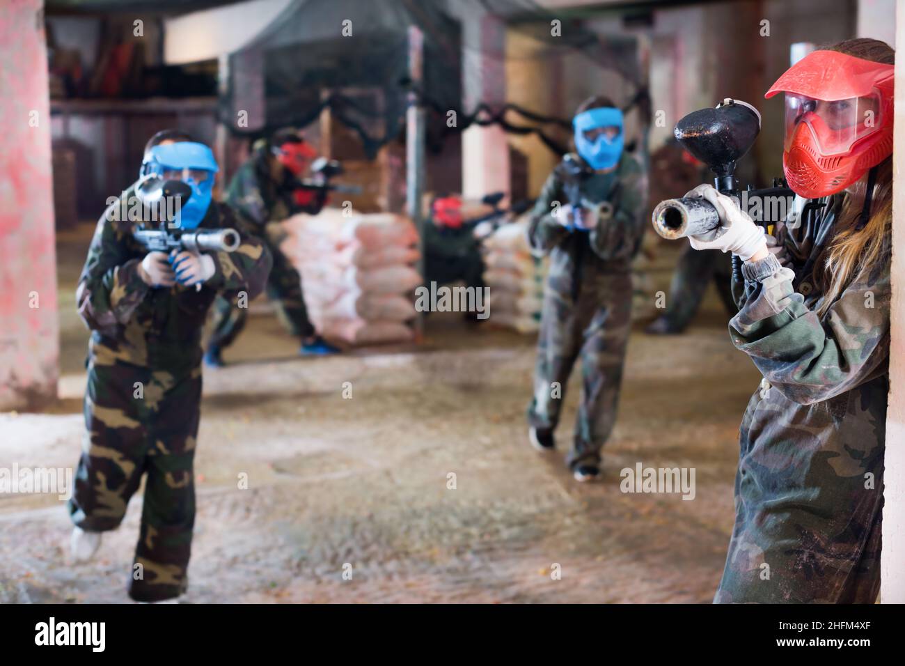 Player in red mask in paintball club Stock Photo - Alamy