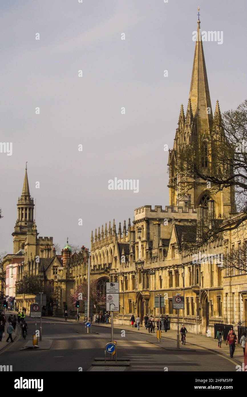 Ornate stone buildings with towers and spires, lining a street in Oxford, England Stock Photo