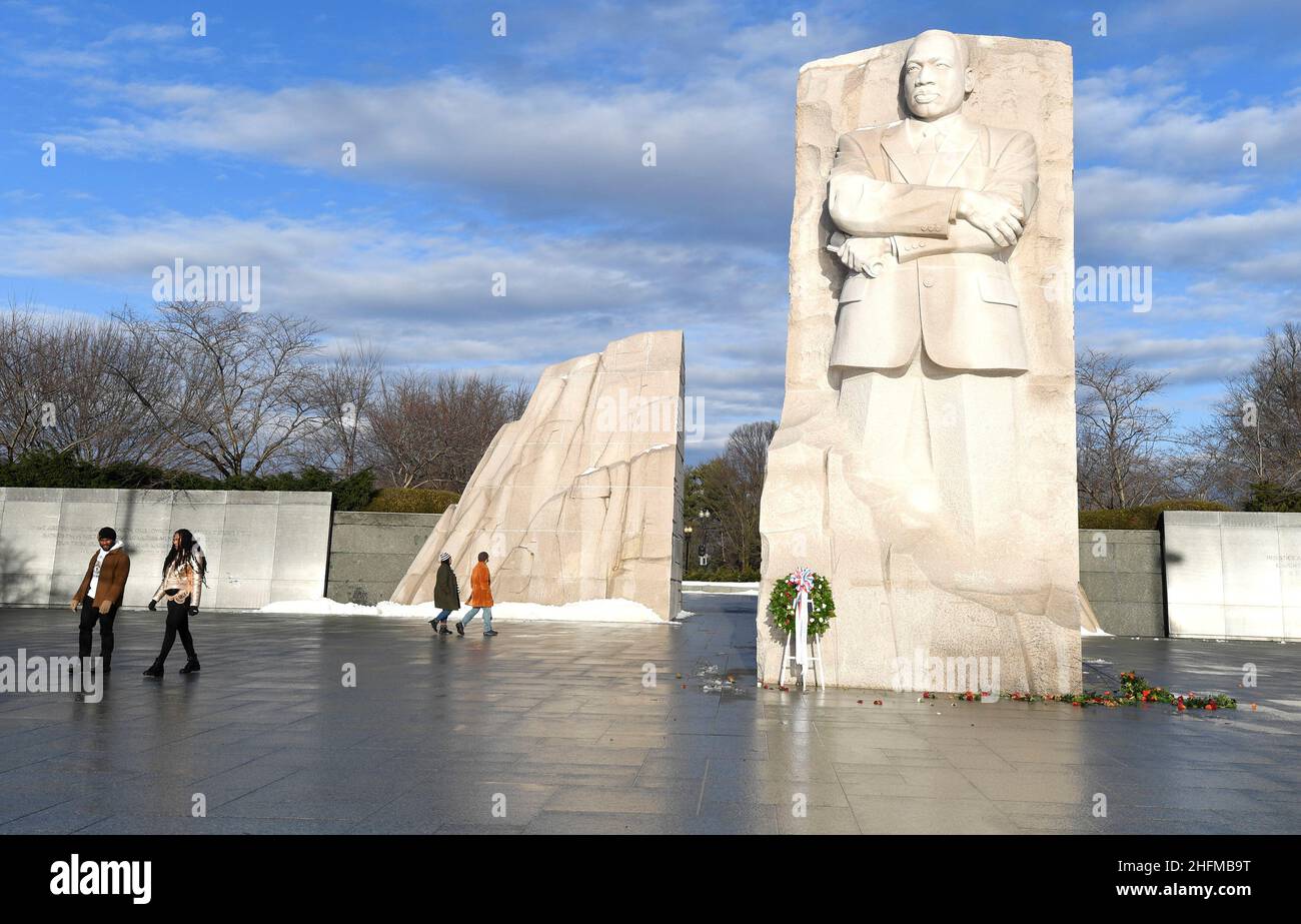 Visitors walk past the Martin Luther King, Jr. Memorial as the sun breaks through clouds after a stormy night, in Washington, U.S., January 17, 2022.   REUTERS/Mike Theiler Stock Photo