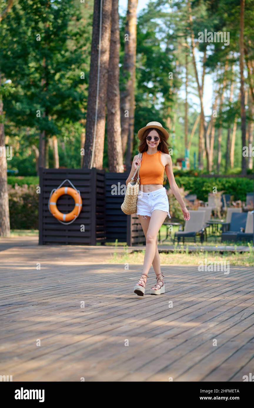 Cute young woman in orange top and 
