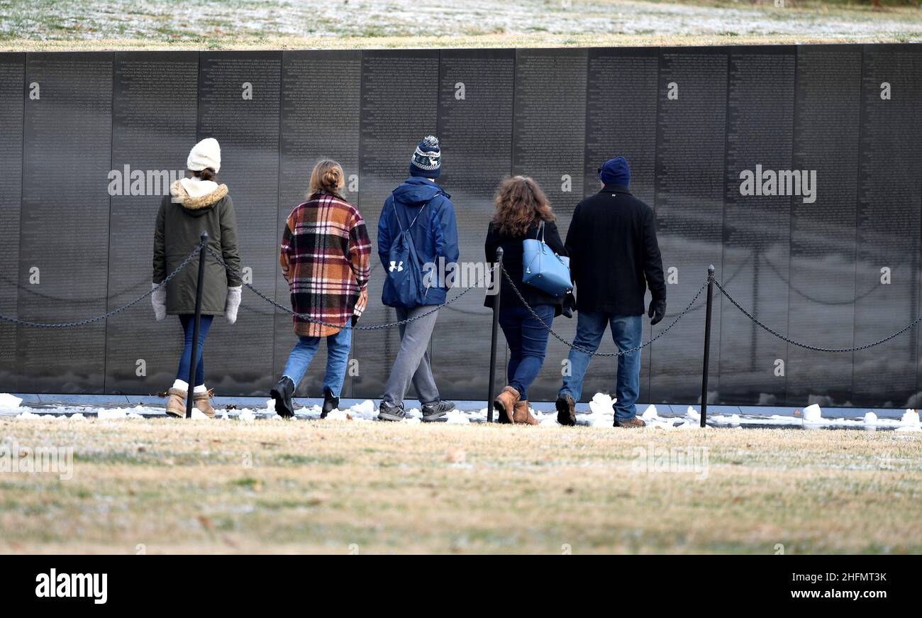 People walk past the Vietnam Veterans Memorial after a stormy night in Washington, U.S., January 17, 2022.   REUTERS/Mike Theiler Stock Photo