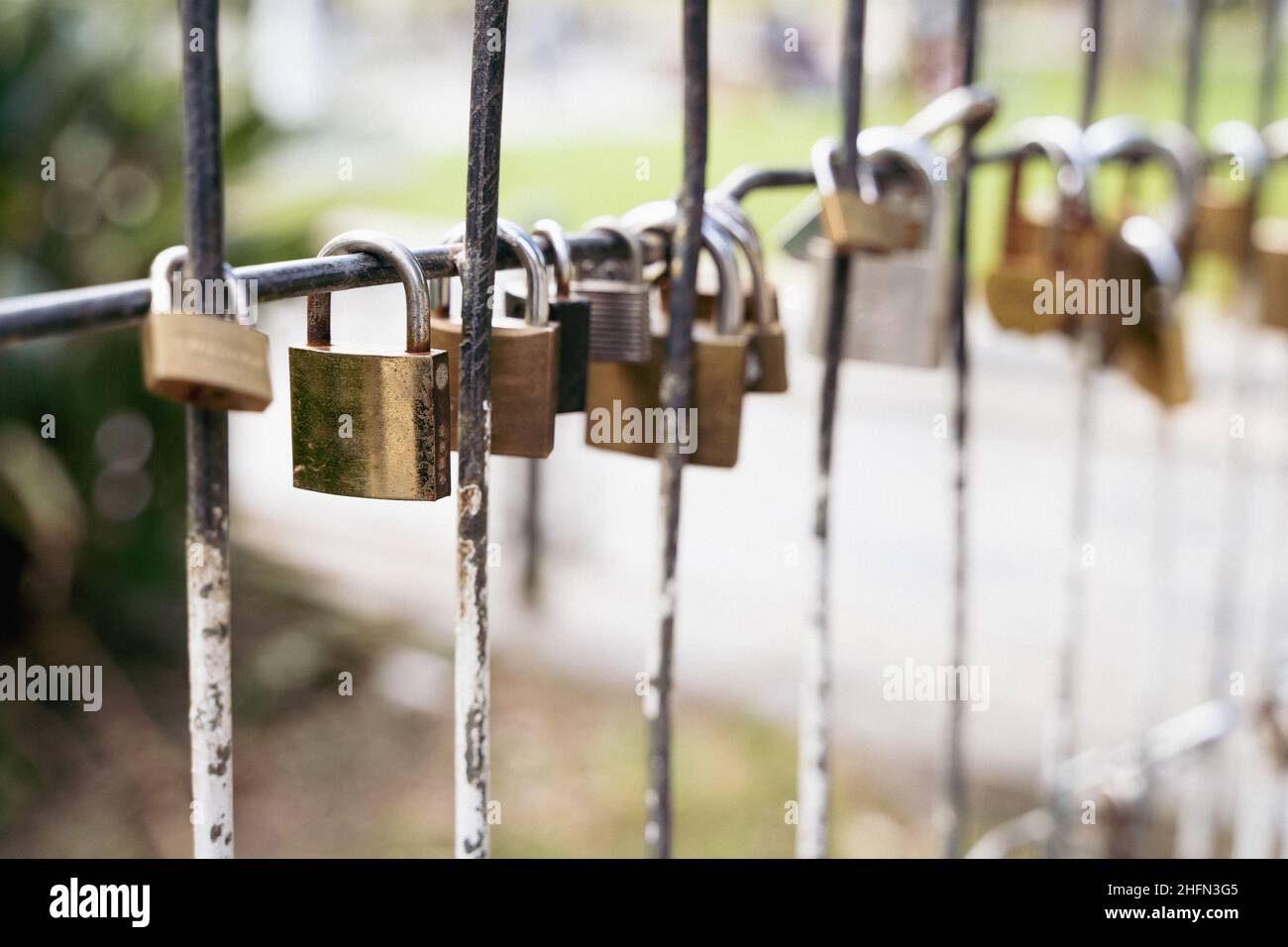 Several padlocks attached to fence. Couple love commitment concept Stock Photo