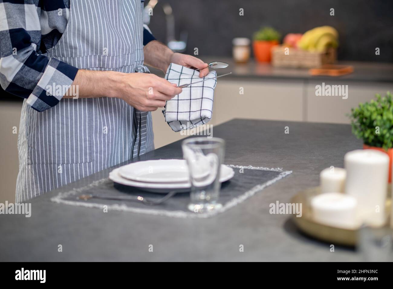 Male hands wiping knife with napkin Stock Photo