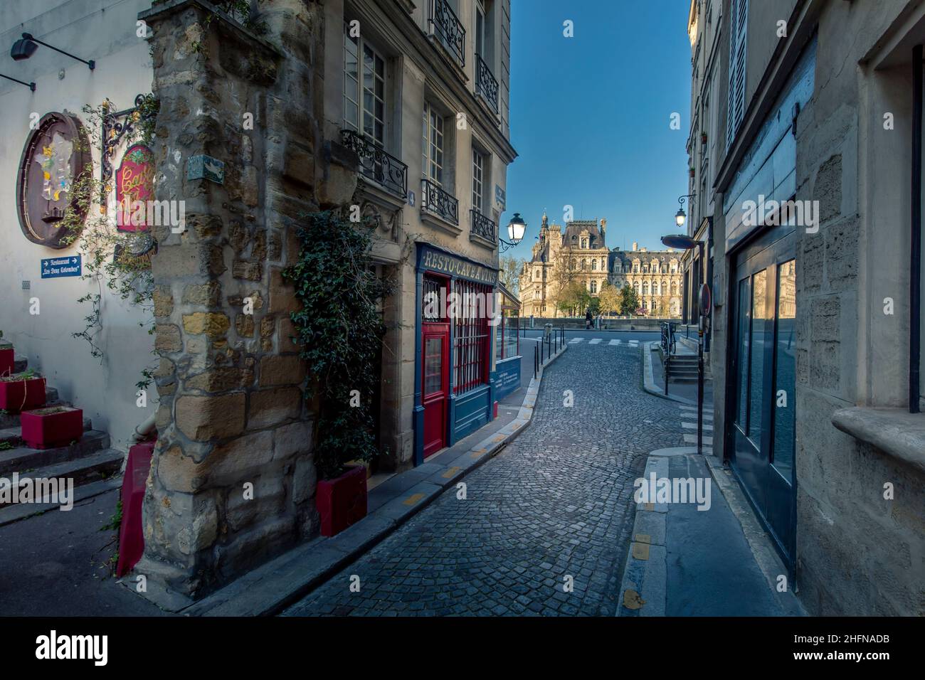 Paris, France - April 3, 2021: Small cosy street with City Hall in background in Paris Stock Photo