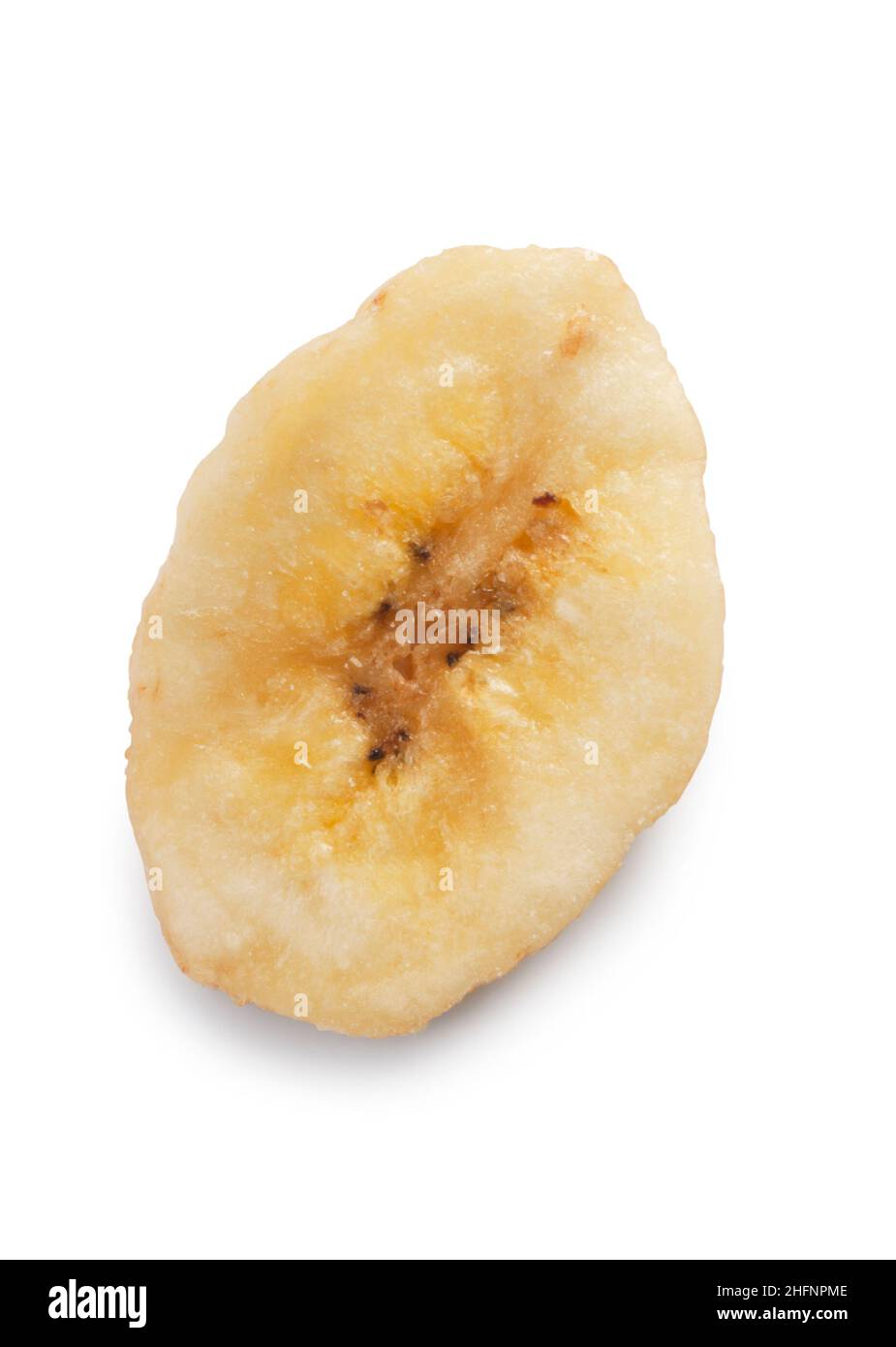 Studio shot of a dried banana chip cut out against a white background - John Gollop Stock Photo