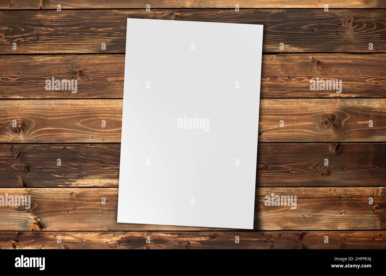 White Paper sheet  isolated on  white background on  wood background Stock Photo