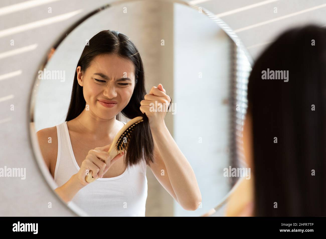 Asian woman having problem of her thick hair Stock Photo