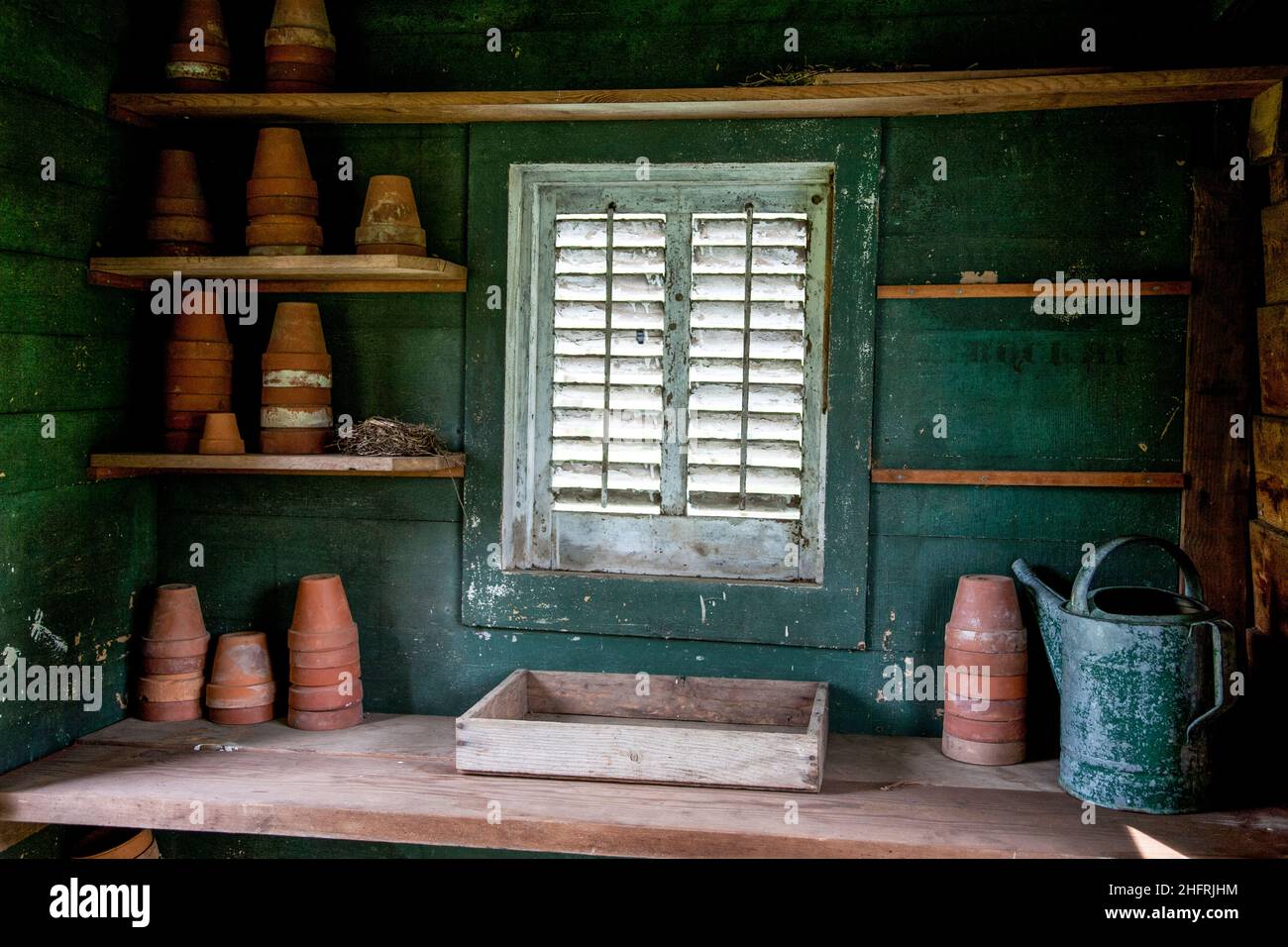Inside potting shed with stacked terra cotta pots watering can, Walnford historic Farm & Mill, county park, Freehold Township, New Jersey, NJ, USA, US Stock Photo