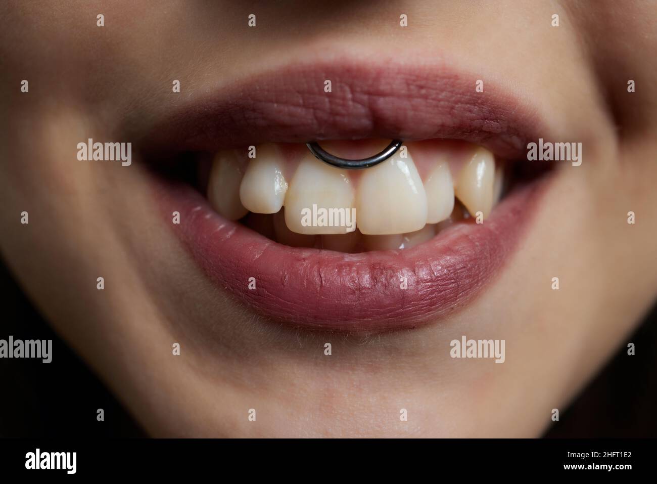 smile or frenulum piercing under the upper lip Stock Photo Alamy