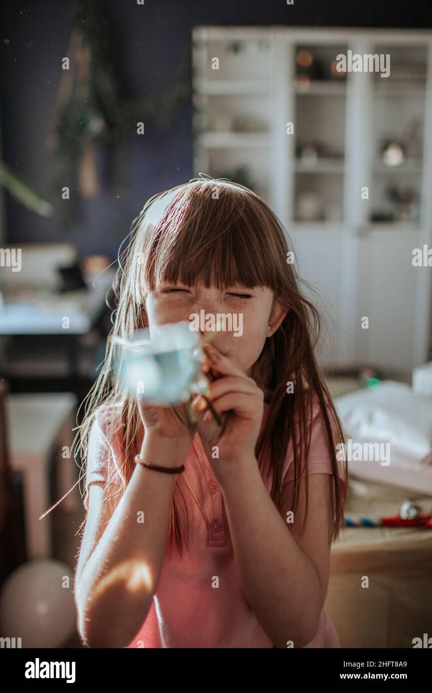 Girl blowing party favor hires stock photography and images Alamy