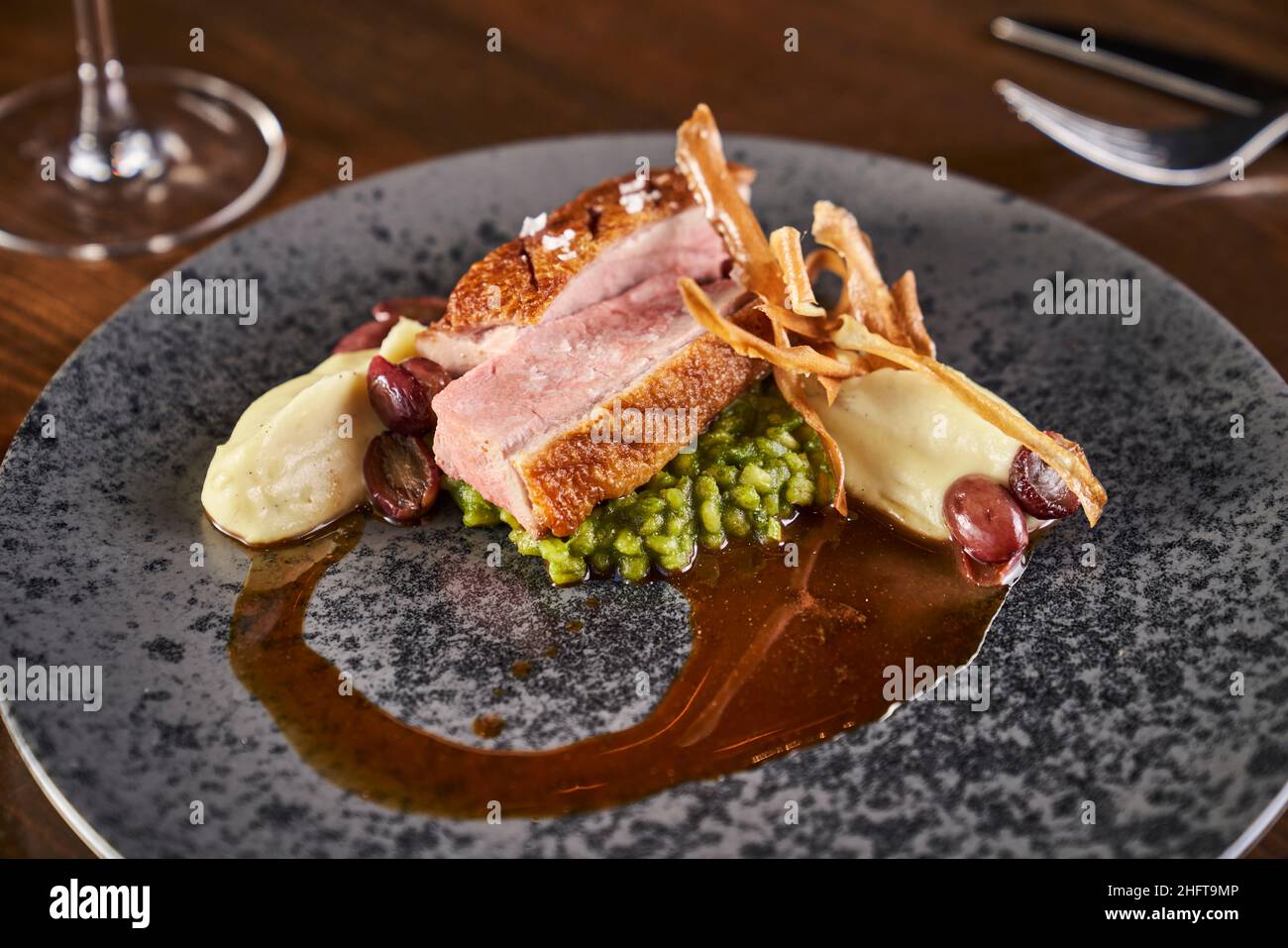 Braised pork belly with smashed peas and pomme puree. Stock Photo