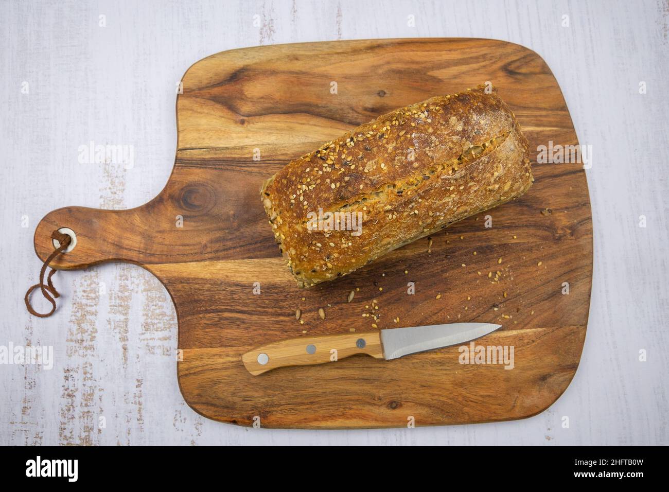 whole grain bread on a wooden board on a white background Stock Photo ...