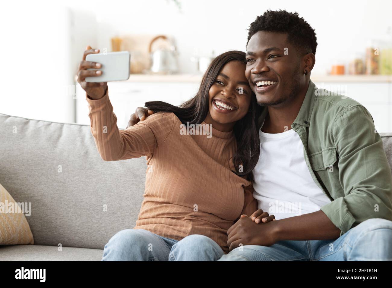 Beautiful black couple taking selfie on smartphone Stock Photo
