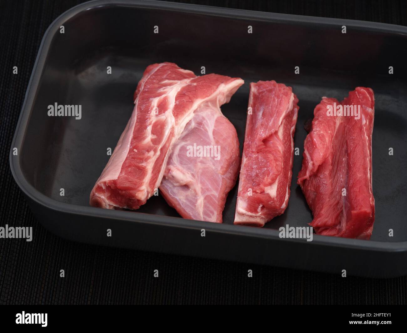 Raw beef ribs in a baking tray ready to be cooked. Close up. Stock Photo