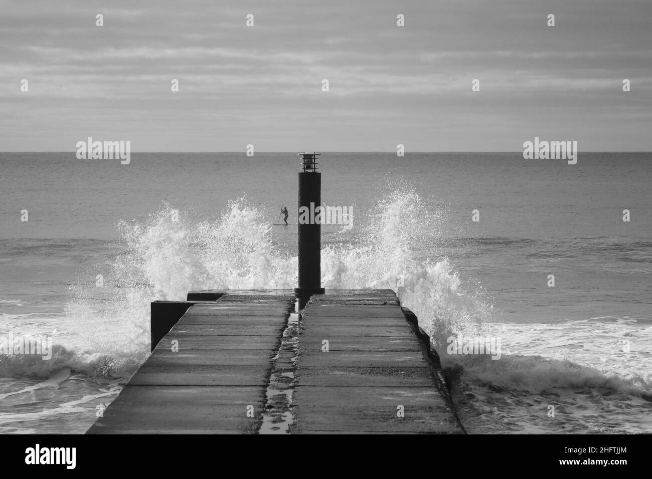 big ocean wave hit in a jetty in a stormy day Stock Photo